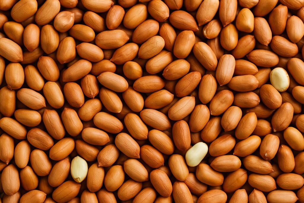 Bulk ground nuts spilling from sack onto wooden surface